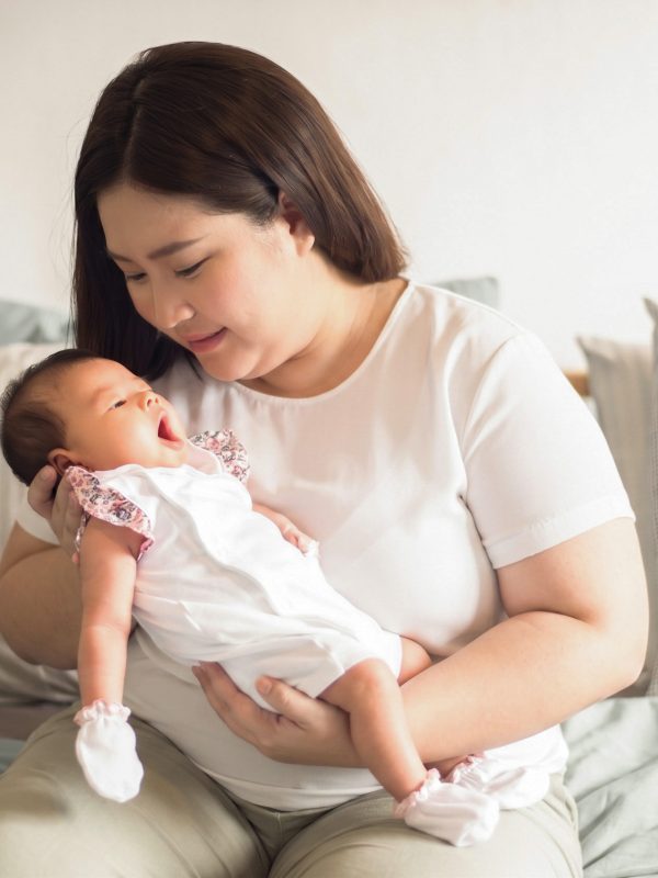 beautiful-woman-holding-newborn-baby-her-arms